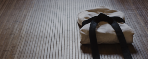 Folded traditional Japanese outfit on the floor of a dojo